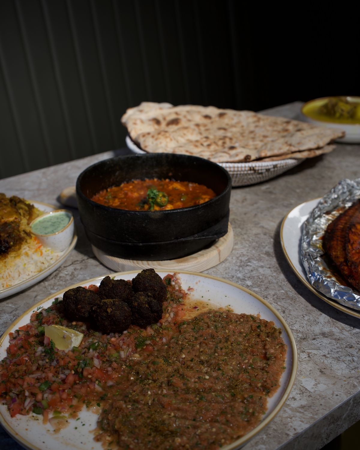 A spread of grills and mezze with warm flatbread